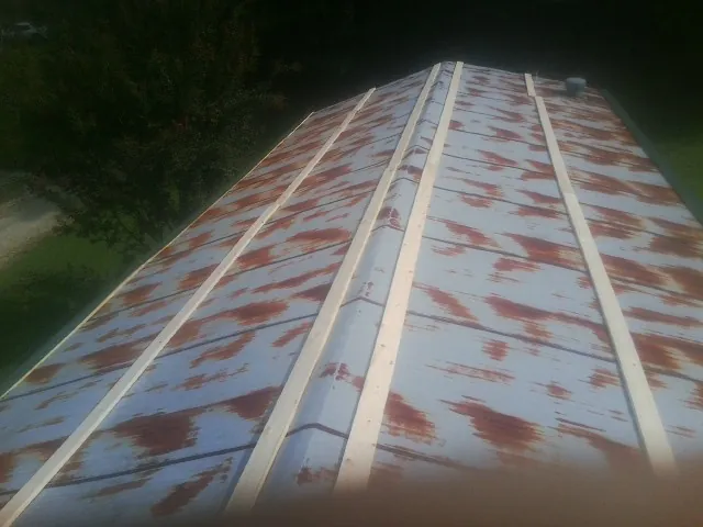 Rusted metal roof panels with new wood purlins before replacement — Storm Damage Roof Repair in Nixon by Roofing Brothers